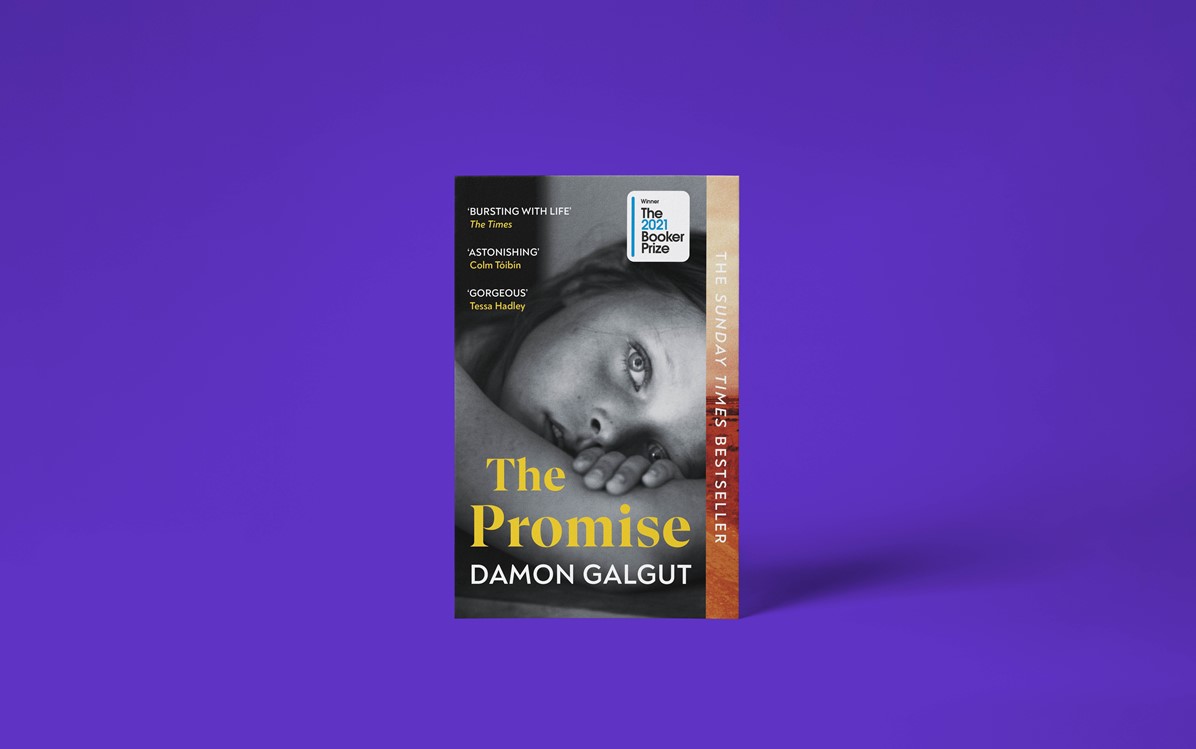 A book cover with the title 'The Promise' by Damon Galgut with a purple background. The cover is a black and white image of a person lying on their side looking at the camera