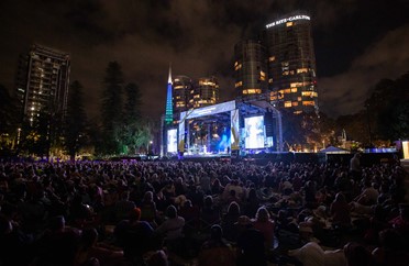 Image of audience members and stage at opera in the park