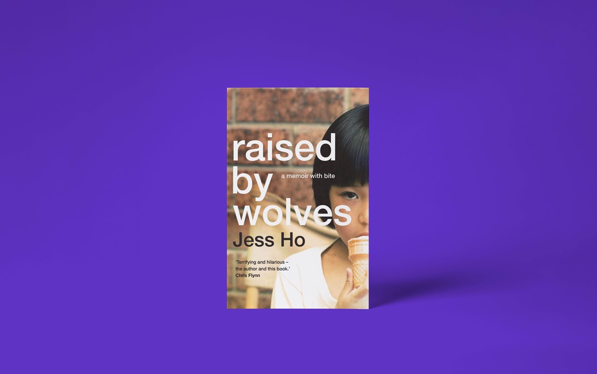 A book cover with the title 'raised by wolves' by Jess Ho with a purple background