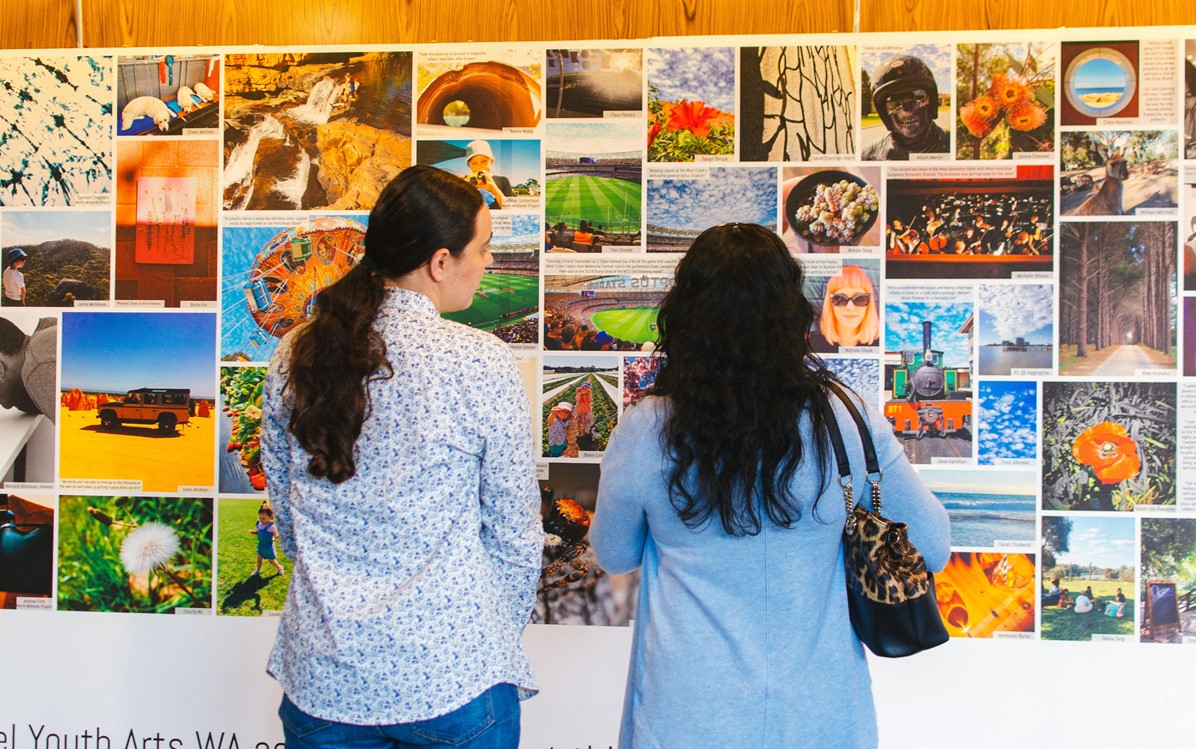 Image of people looking at a banner of different images
