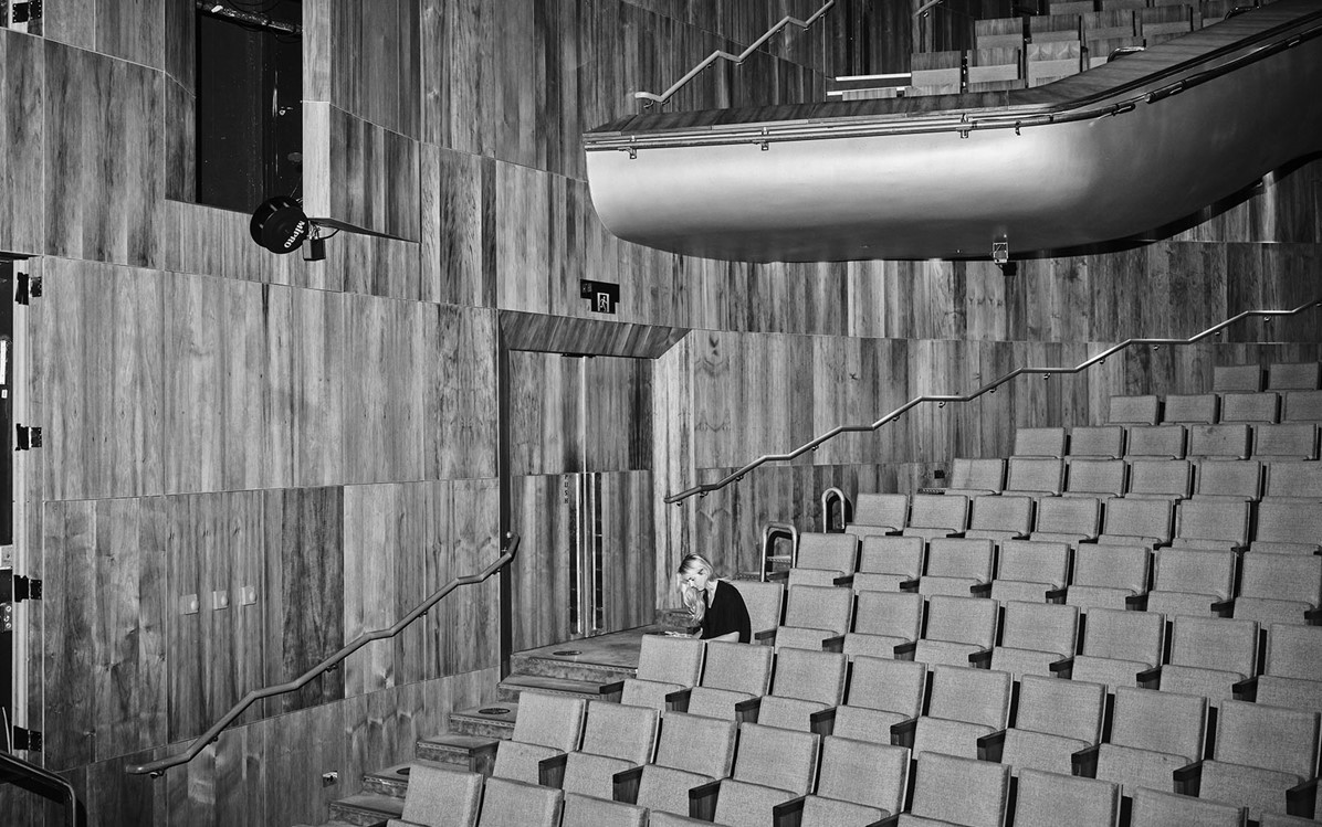 black and white image of the Heath Ledger Theatre main auditorium seating. One person is seated on a far chair.  Credit Duncan Wright