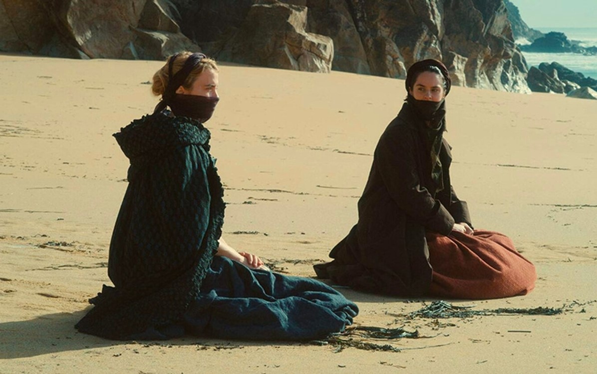 Image of two women sitting on the beach, from ''Portrait of a Lady On Fire''