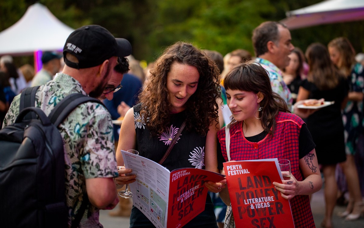 Image of people looking at Perth Festival Literature & Ideas booklet