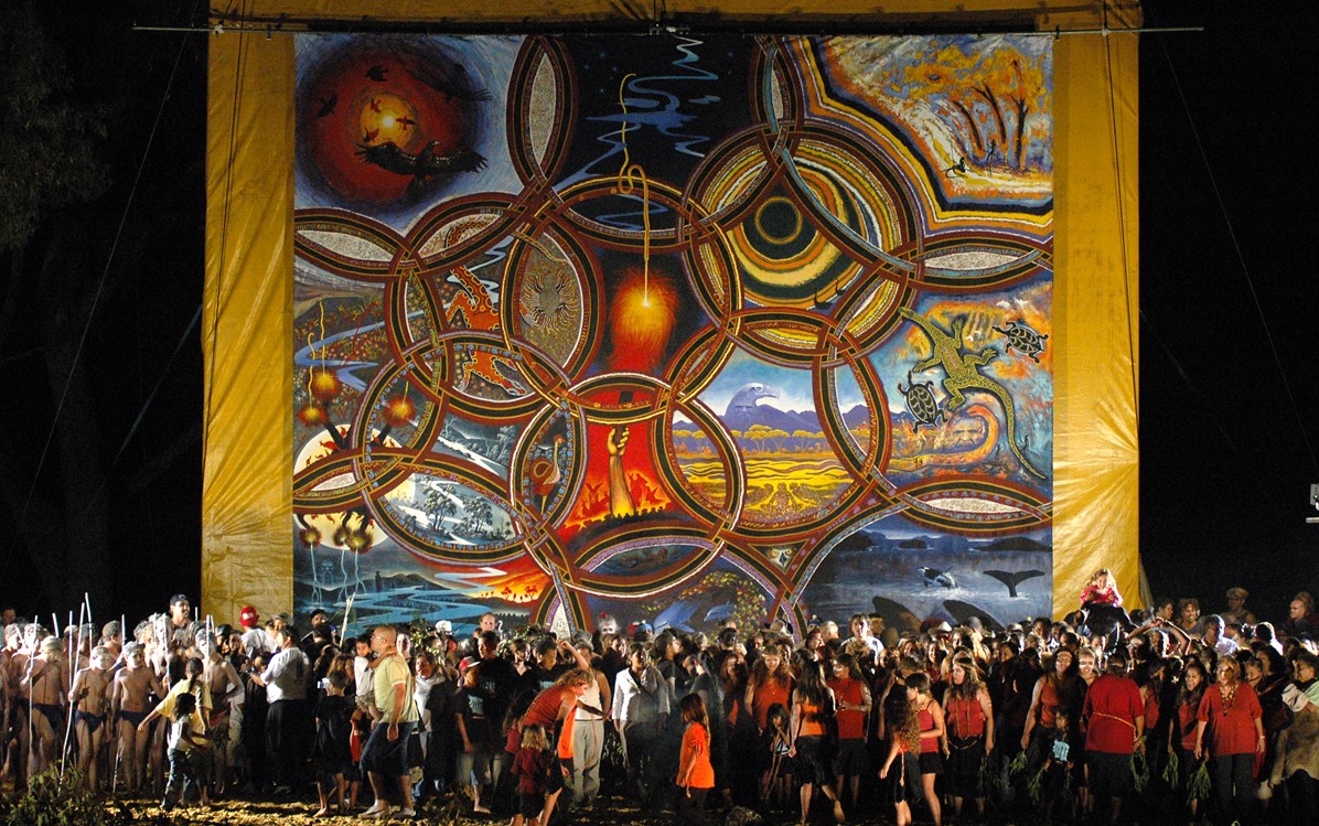 Image of people gathering at night in front of the Ngallak Koort Boodja Canvas.