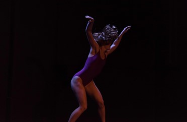 Image of a dancer with arms in the air in ''Move Move Move''